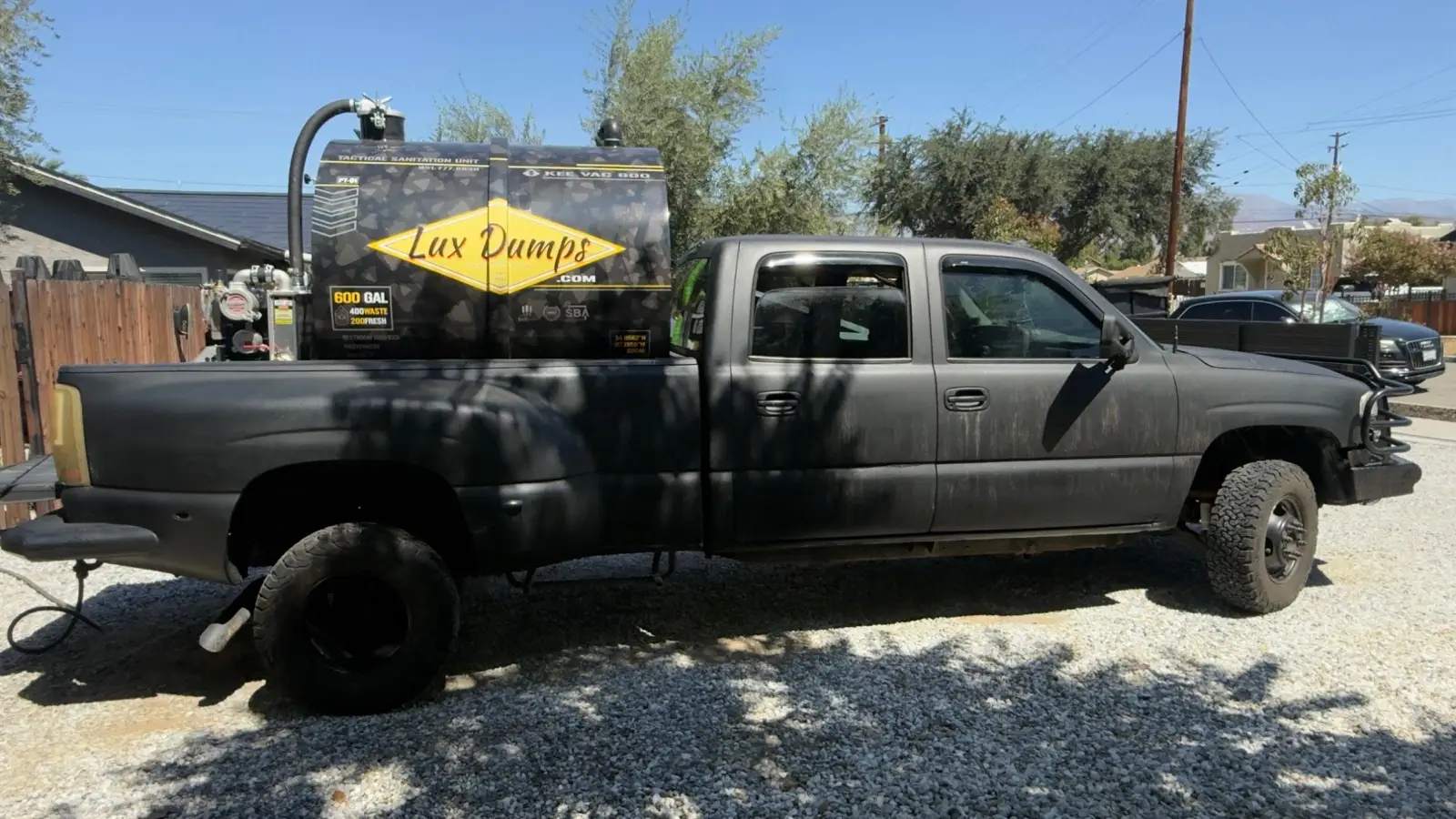 Lux Dumps 600-gallon vacuum pump truck, a wrapped Kee Vac unit on a one-ton dually
