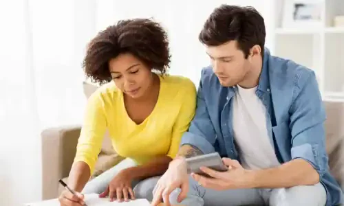 Couple with papers and calculator at home