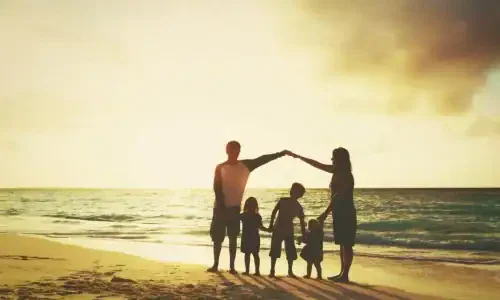Happy family with kids play at sunset beach
