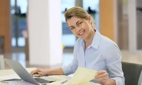 Businesswoman working in office on laptop