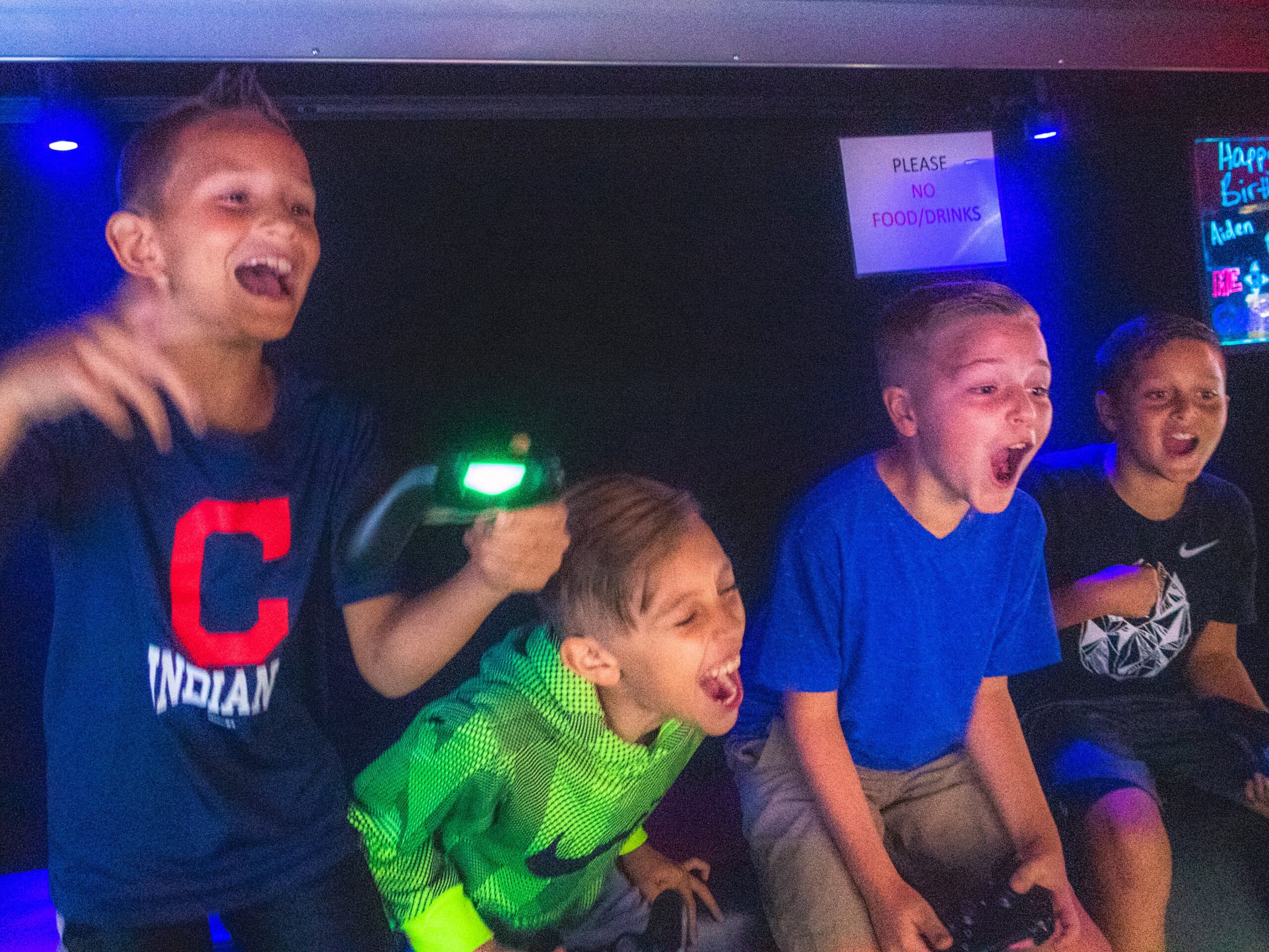Inside the Me 2 You Game Truck with multiple gaming screens and kids playing