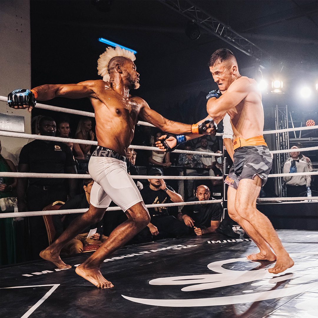 Intense MMA fight at P7 Arena, Media One Hotel, with two fighters exchanging blows in a high-energy, action-packed match