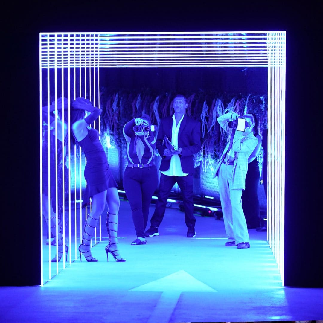 Futuristic neon-lit entrance at P7 Arena, Media One Hotel, with capturing guests at an exclusive nightlife event