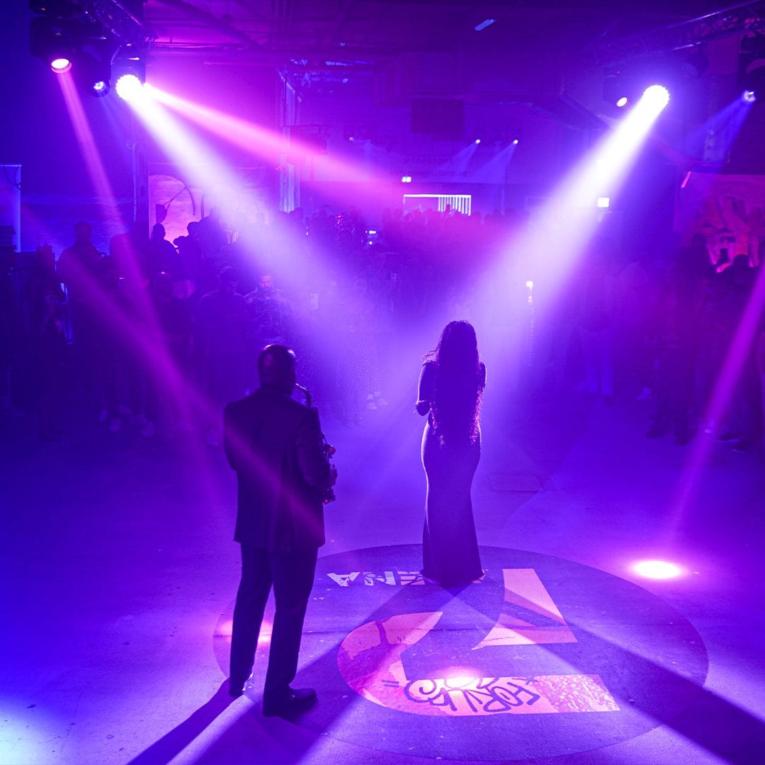 Live music performance at P7 Arena, Media One Hotel, featuring a saxophonist and singer under vibrant purple stage lights