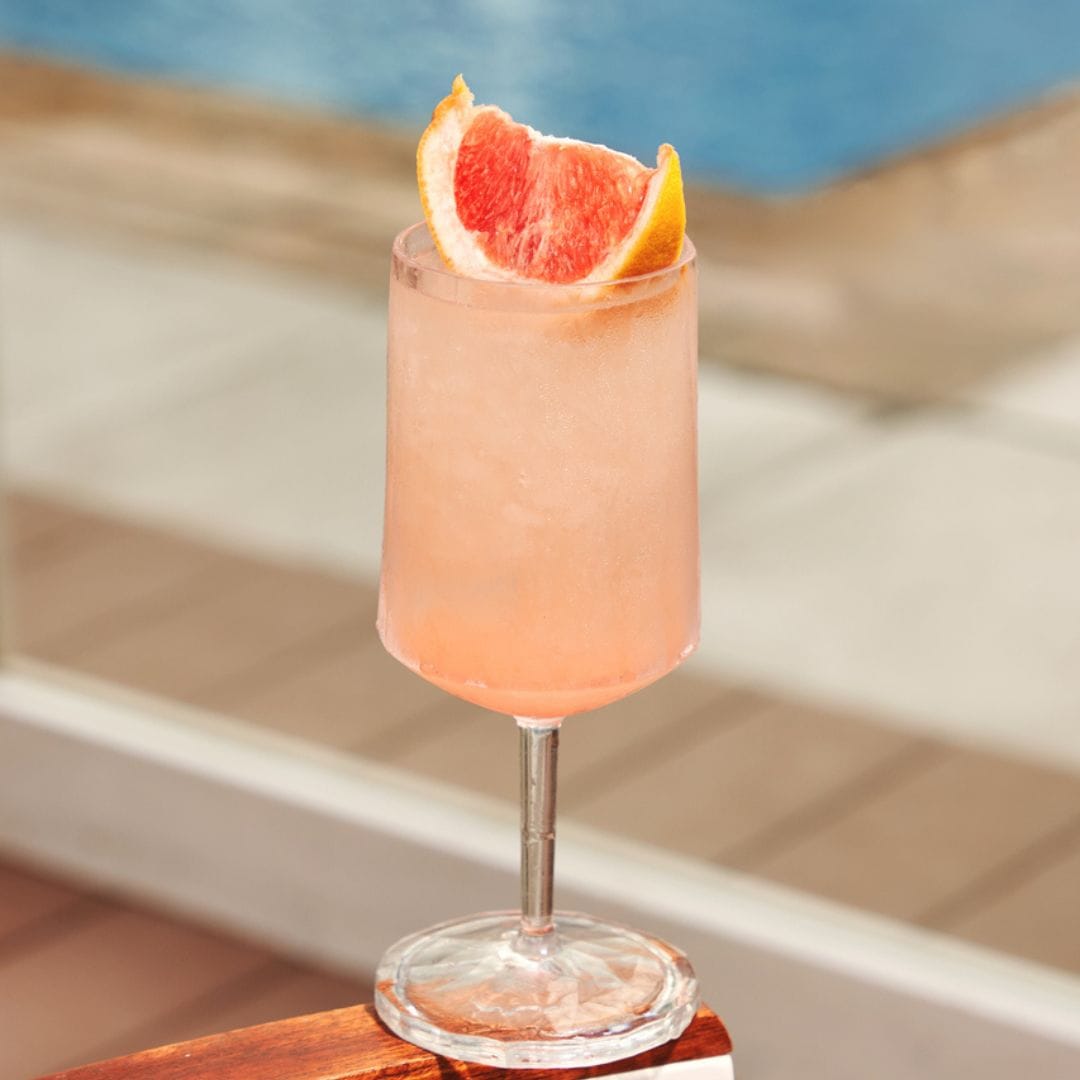 Refreshing grapefruit cocktail served poolside at Coco Lounge, perfect for a sunny day by the water.