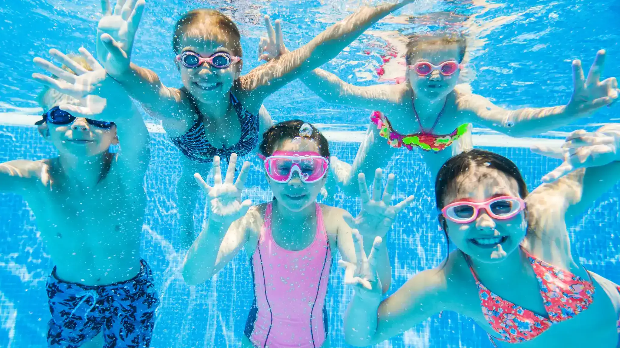Families enjoying swimming at Mighty Splash Fosse Way School