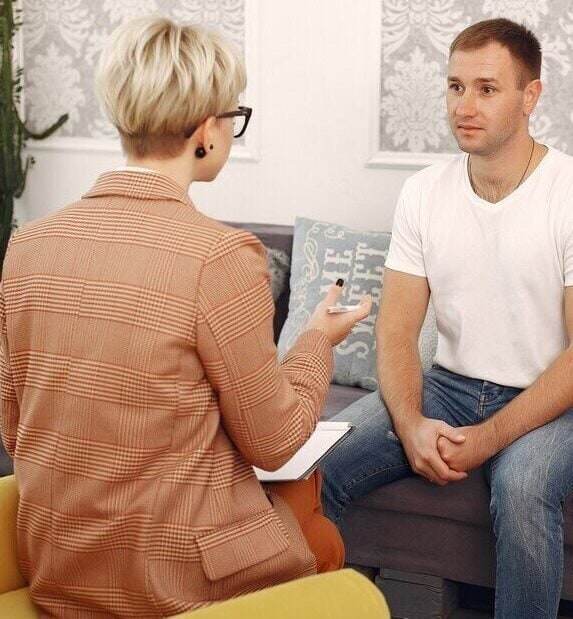 man-sitting-psychologist-s-office-talking-about-problems_1157-28377
