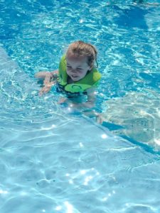 disney fantasy cruise ship activities child swimming with life vest in Disney Fantasy pool