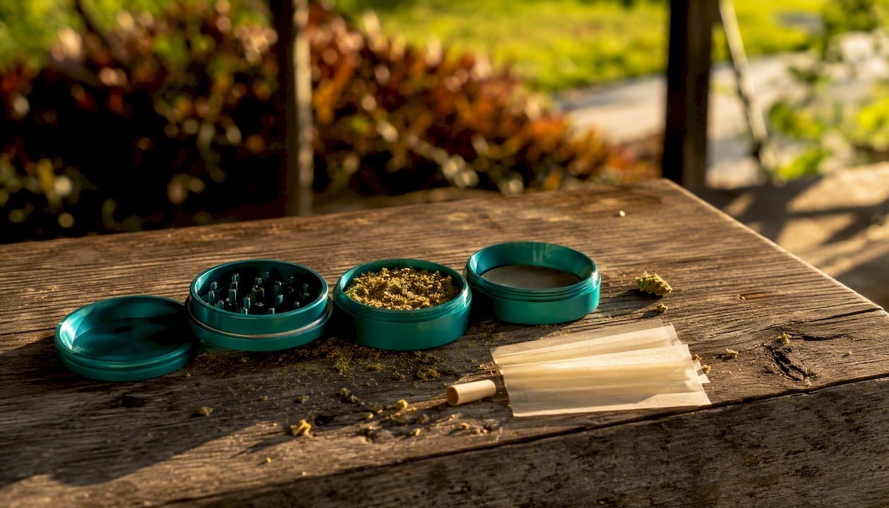 Cannabis grinder with rolling papers and filter tips
