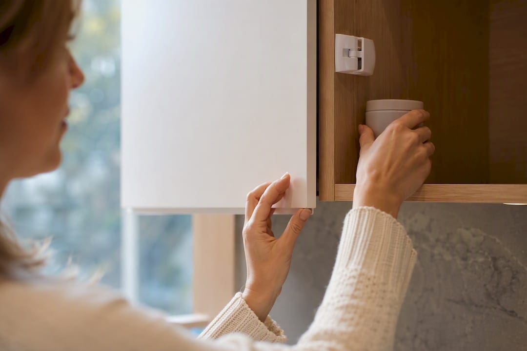 Hands securing an edible container in cabinet