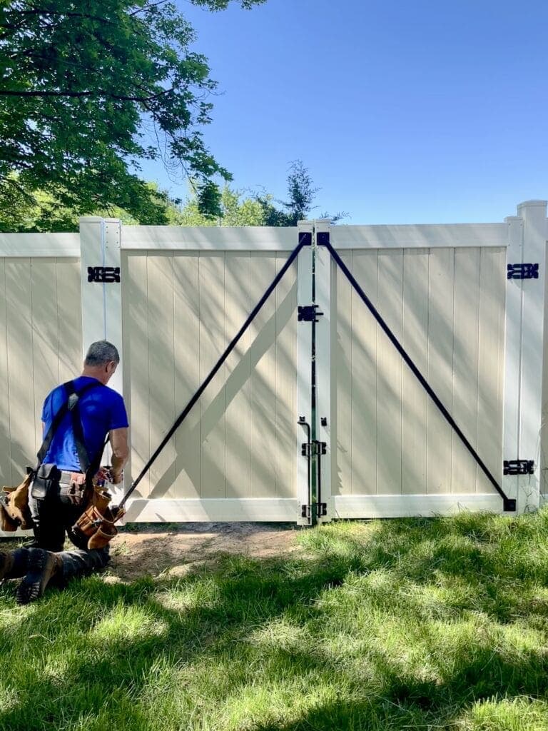 Mark fixes vinyl fence gate with adjustable wrench MyFixitUpLife How to Easy Vinyl Fence Gate Repair So It Will Close MyFixitUpLife fix a vinyl fence gate vinyl gate fence repair MyFixitUpLife