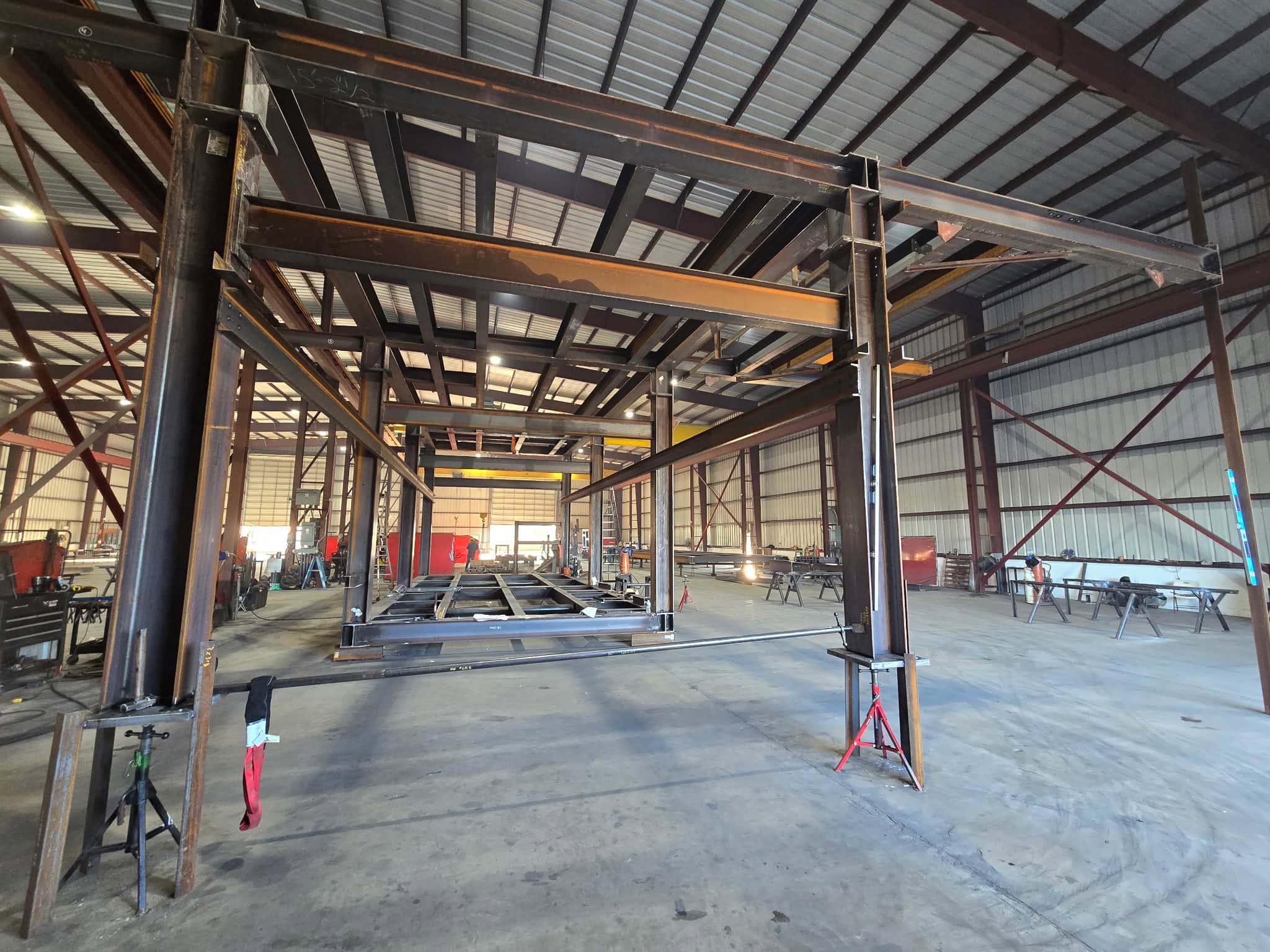 Multi-level structural steel equipment structure with columns and beams being welded inside the WeldIT fabrication shop in Houston
