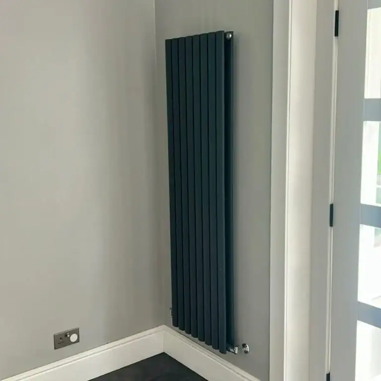 Matt black vertical radiator installed on grey wall in East End Glasgow home by NB Gas & Plumbing