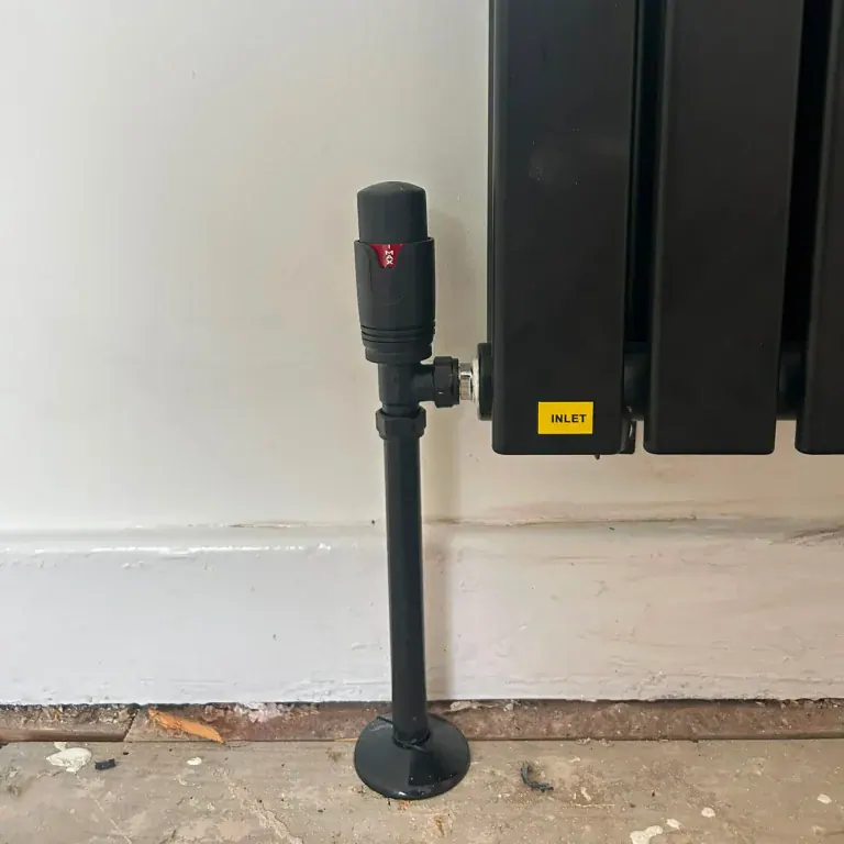 Matte black thermostatic radiator valve TRV and pipe sleeve fitted by NB Gas And Plumbing