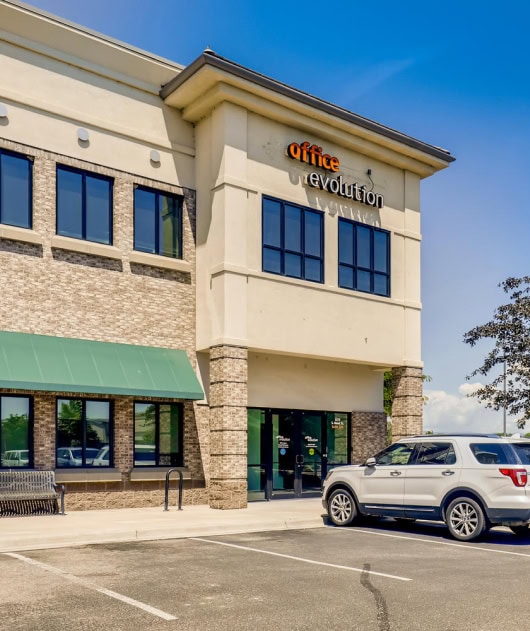 phOffice evolution franchising office building exterior with signage and parking lot, showcasing the franchise's location and branding opportunities in the workspace industry.