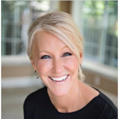 Professional smiling woman in an office setting promoting Office Evolution franchising opportunities.