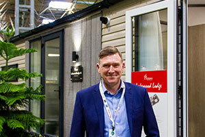 Gary Corlyon, managing director of Victory Leisure Homes, and the new Lakewood Lodge holiday home.