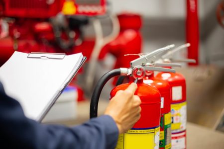 Two fire extinguishers being checked
