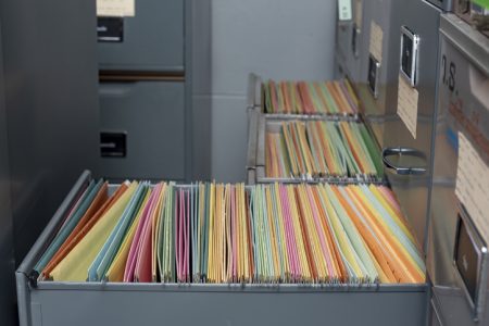 Important documents arranged in a file placed in a filing cabinet.