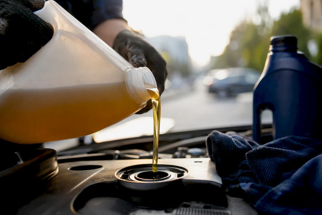 Pouring synthetic oil into engine close-up