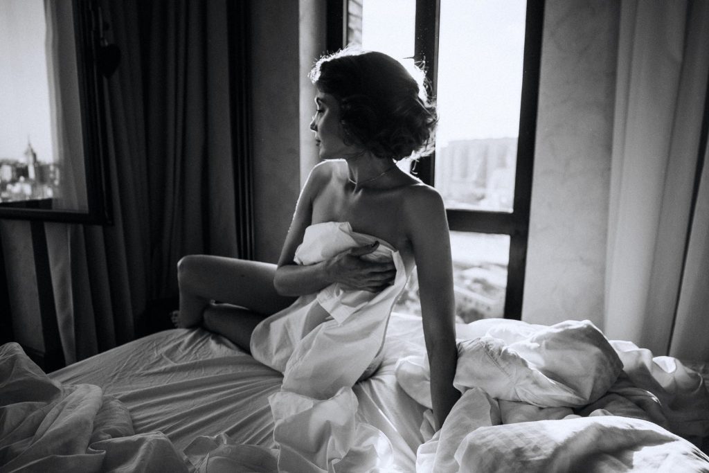 An attractive woman seductively posing, demanding our attention