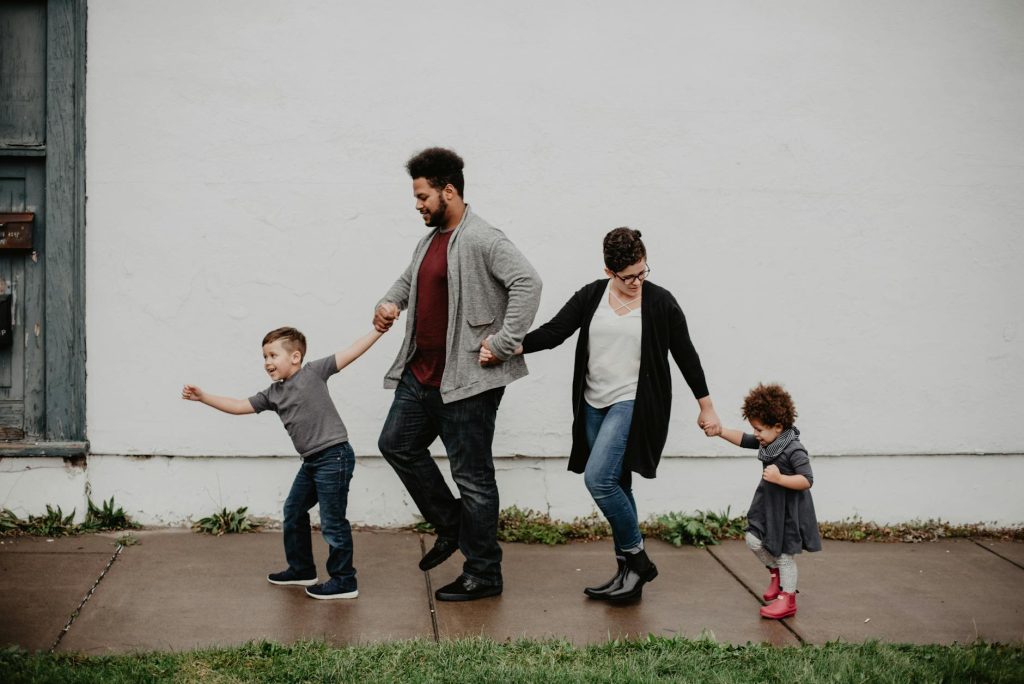 A family holding hands together, all well-behaved