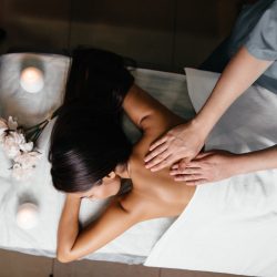 Portrait of fresh and beautiful brunette woman taking head massage