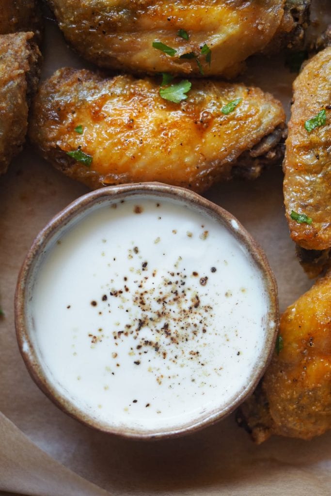 Paula's Apron Crispy Garlic Butter Chicken Wings Yoghurt lemon dip for the crispy garlic butter chicken wings. The chicken wings with the butter sauce are already beyond amazing but... a touch of freshness always goes well with spicy dishes and with fat ingredients (in this case the butter). Specifically, dairy, like yoghurt in this case, is perfect to offset the spiciness and lemon is the perfect pairing to balance the butter sauce.