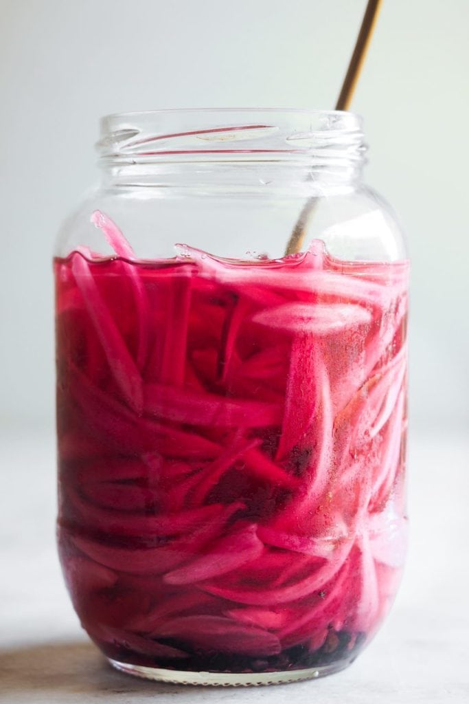 Paula's Apron Easy Homemade Pickled Red Onion Making Homemade Pickled Onions couldn't be easier or quicker. And what do you get? A tangy, slightly sweet, and punchy onion made with just a handful of ingredients and a little bit of patience (some resting time is needed). It's a kitchen staple that you must include in your repertoire cause it's a super versatile flavour and colour booster. I'm sure that if you make this easy homemade pickled red onion once, you'll come back for more! | Paula's Apron Recipe