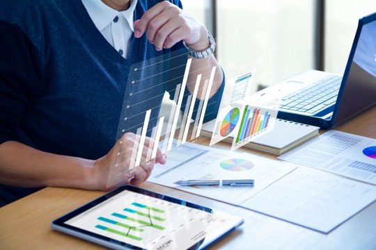business-man-expanding-futuristic-virtual-screen-modern-tablet-min
