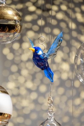 festive glass bird ornament with holiday decor 287 x 430