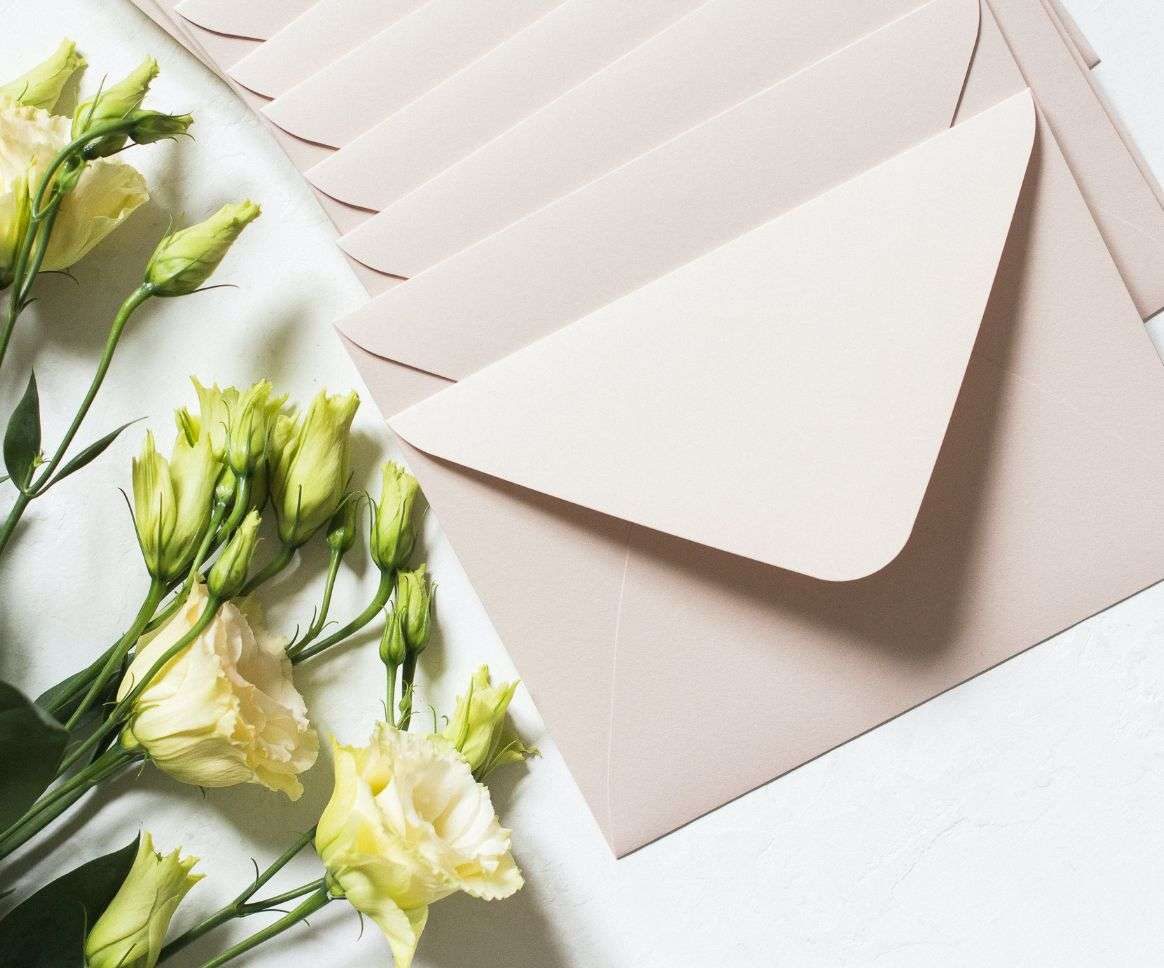 white envelopes with white roses on a white background white envelopes with white roses on a white background