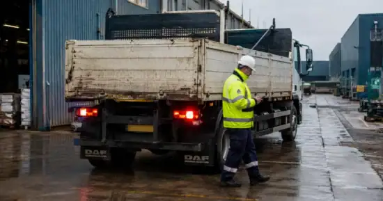 Reversing truck nearly hits worker