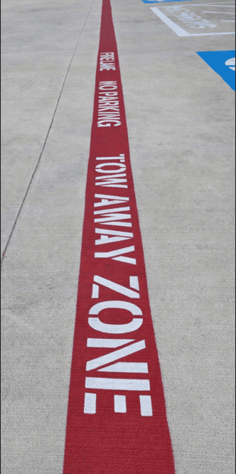 Tow away zone and red fire lane no parking curb marking | Podium Pavement Works North Houston TX