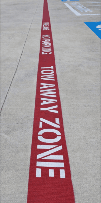 TOW AWAY ZONE fire lane striping - red painted fire lane with lettering
