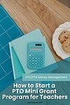 calculator atop papers and notebook on tabletop