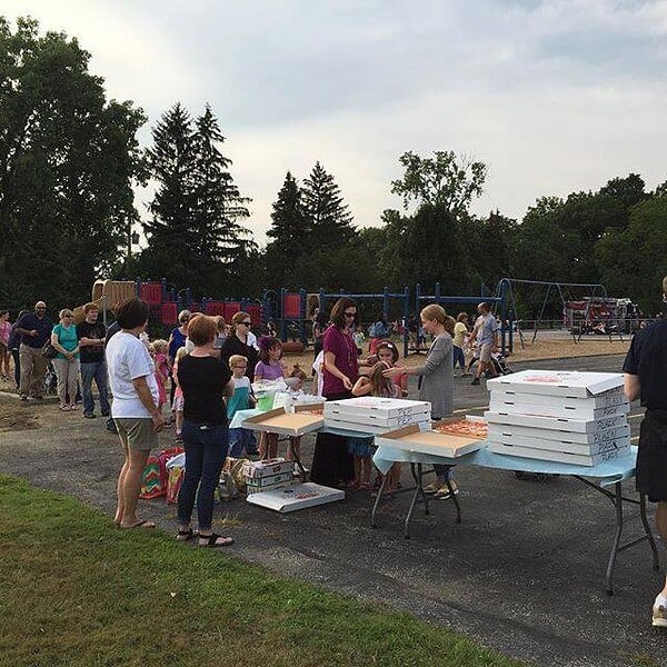 families on a playground at a PTO back to school party
