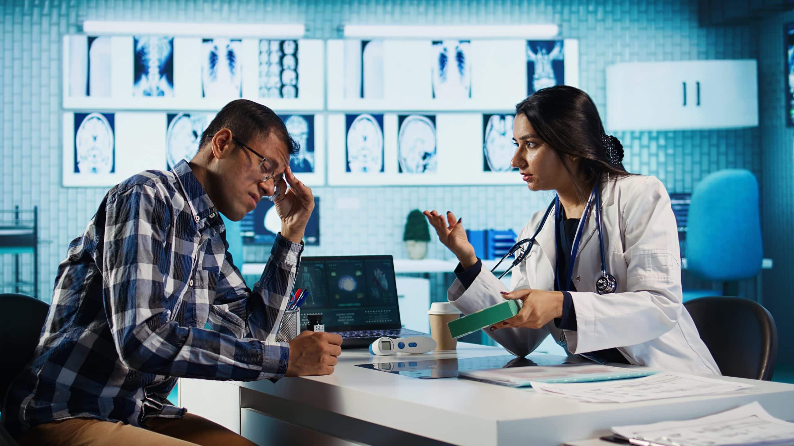 Indian medic giving a box of supplements and antibiotics at check up, offering support and prescription drugs for wellness. Male specialist recommends tablets with the right dosage. Camera B.