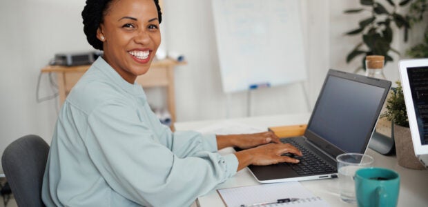 Portrait of smiling beautiful businesswoman in a home office