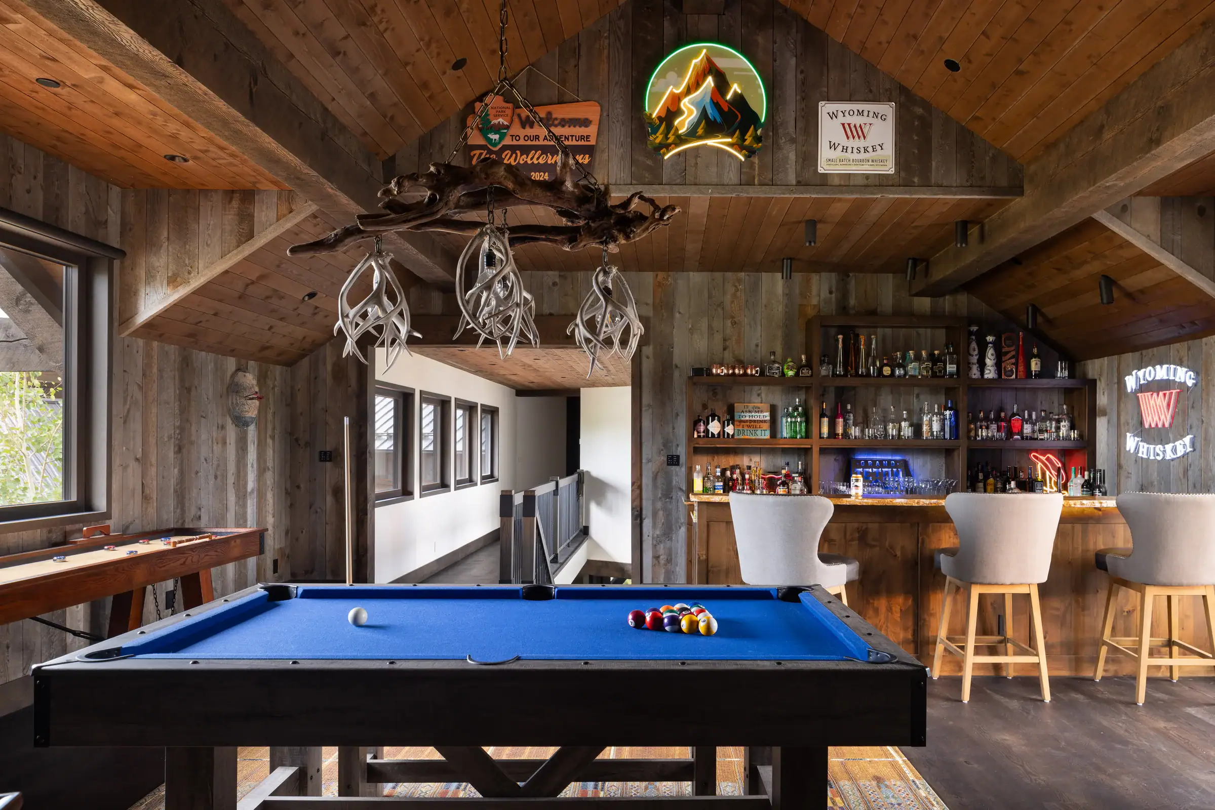 Upper entertainment loft with timber framing and custom bar