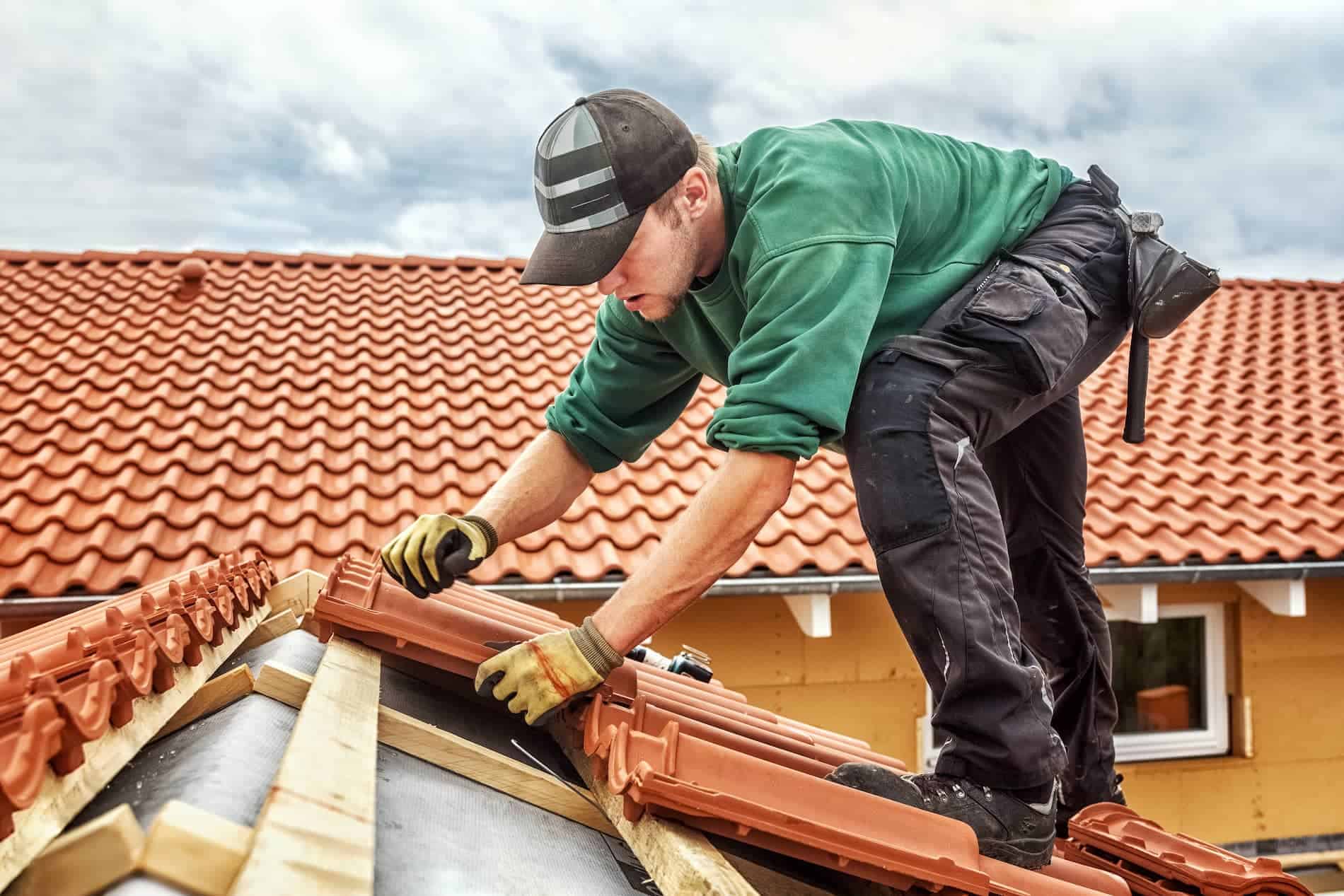 Roofer replacing tiles