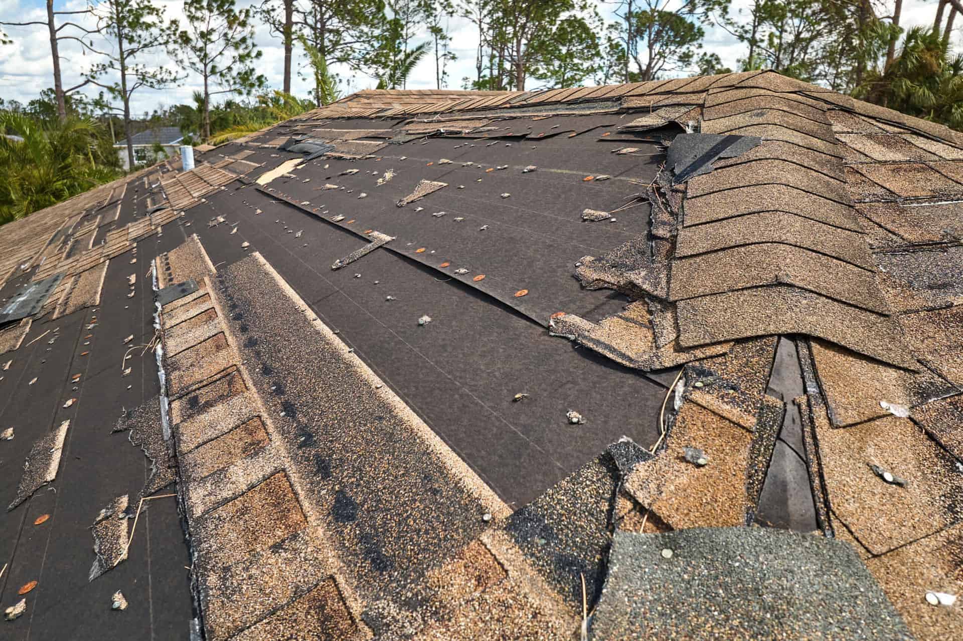 Hurricane Ian destroyed a house roof in Florida residential area. Natural disaster and its consequences.