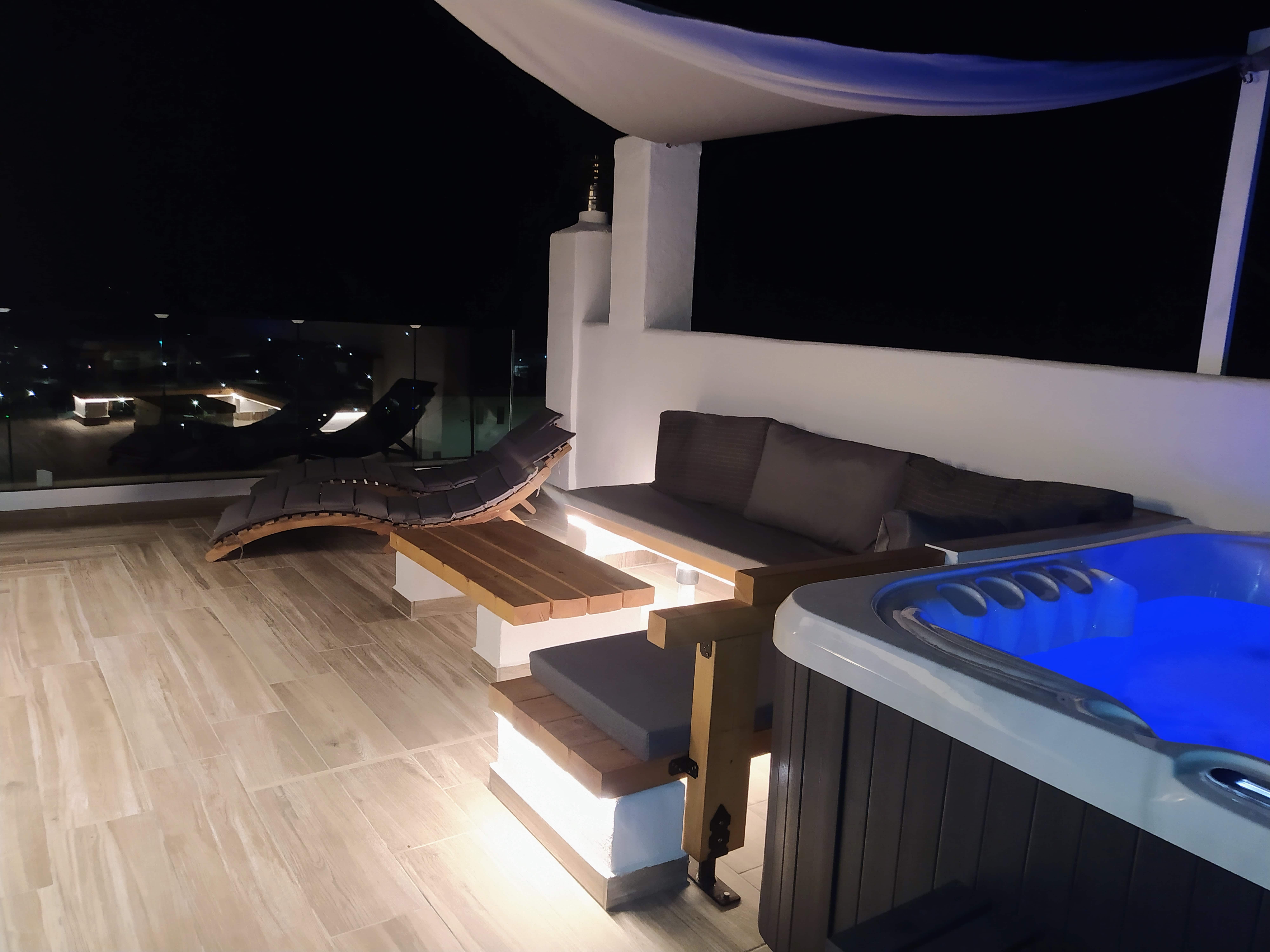Luxury rooftop terrace with jacuzzi and lounge seating at Rustic House Embonas Rhodes