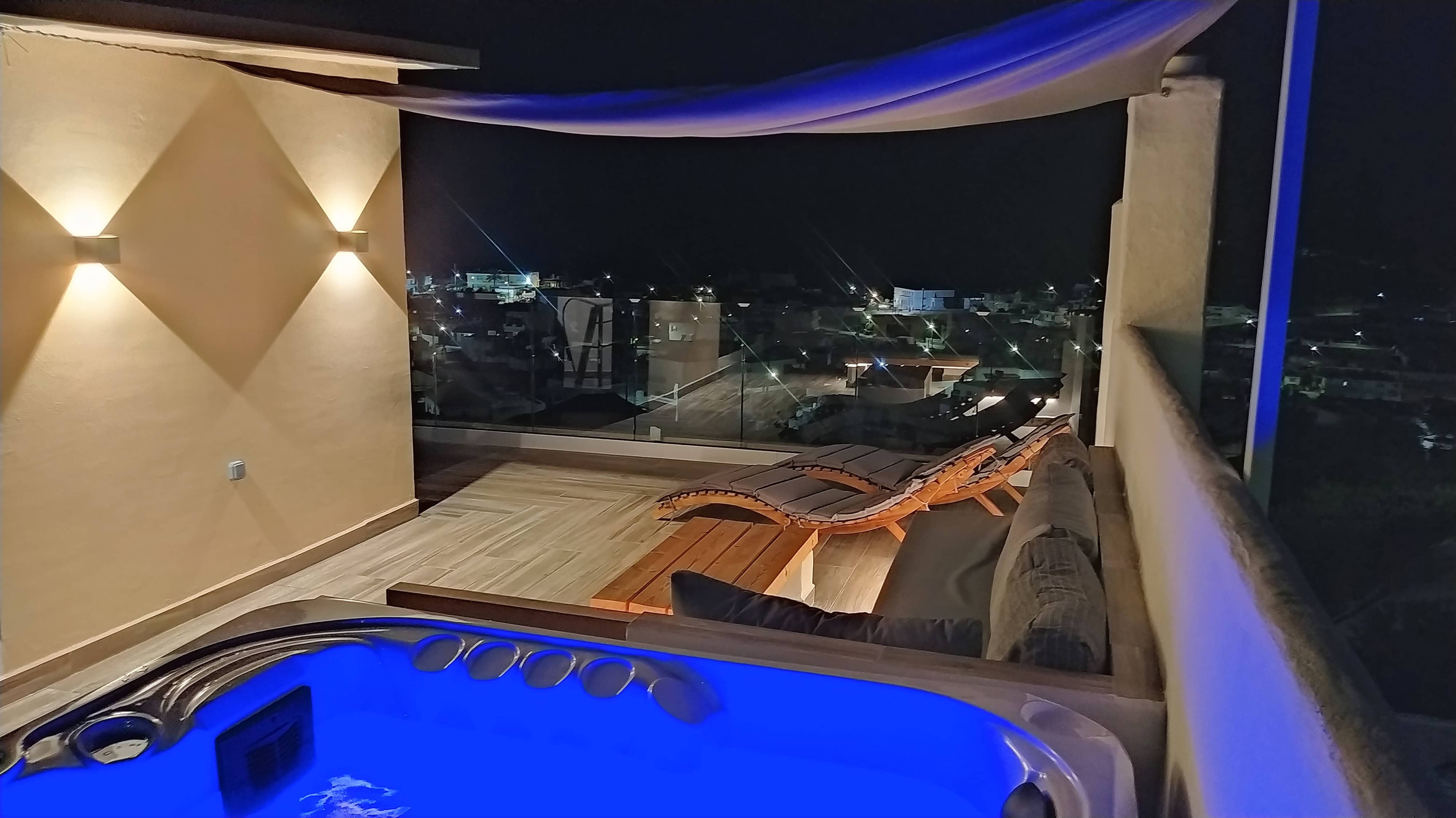 Luxury outdoor terrace with jacuzzi and lounge area at Rustic House Embonas Rhodes