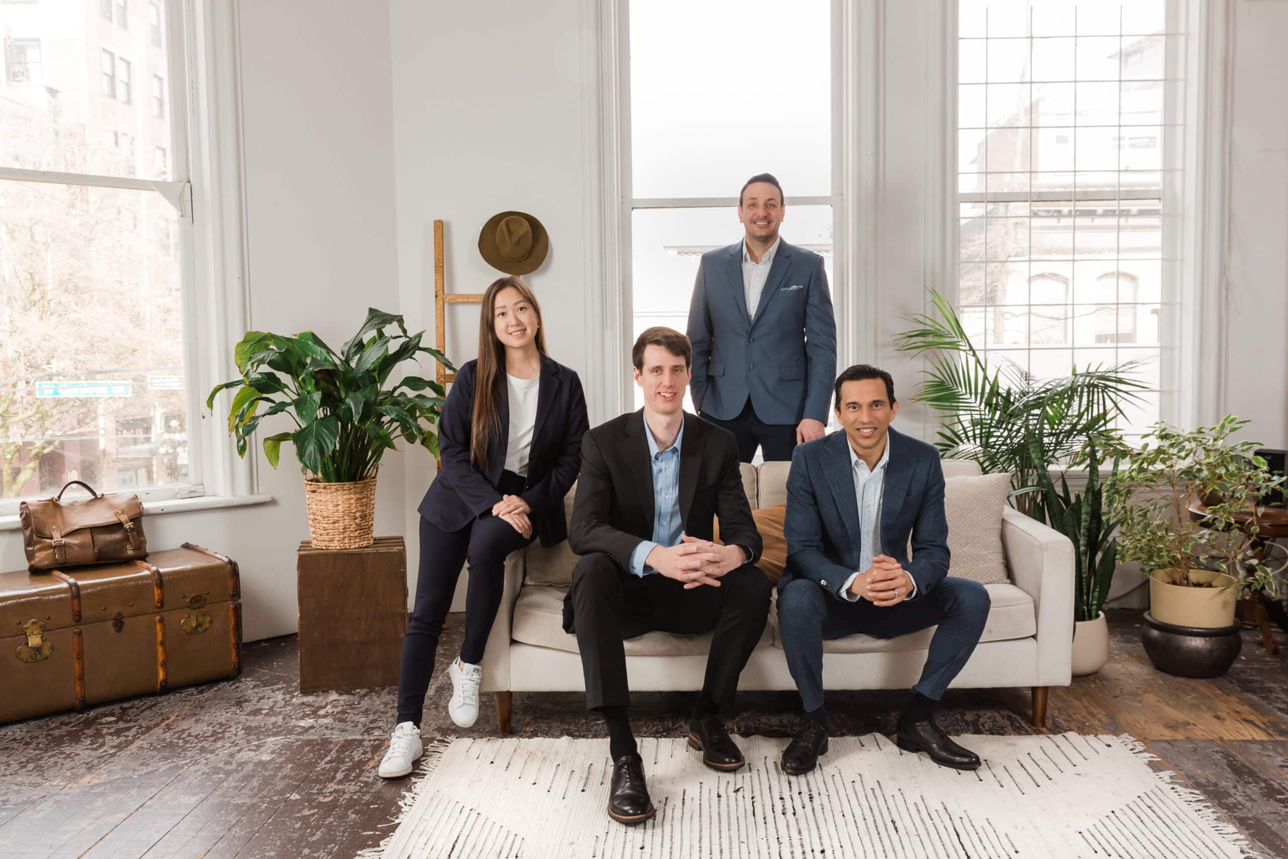 safe pacific financial team sitting in front of a window