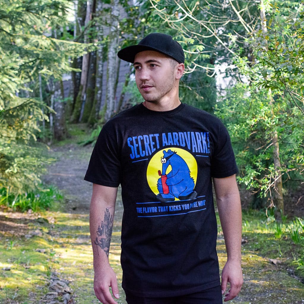 Person wearing a black secret aardvark t-shirt