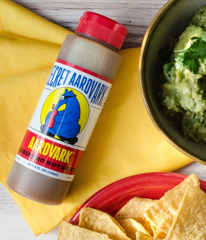 Aardvark Habanero Hot sauce next to guacamole and chips