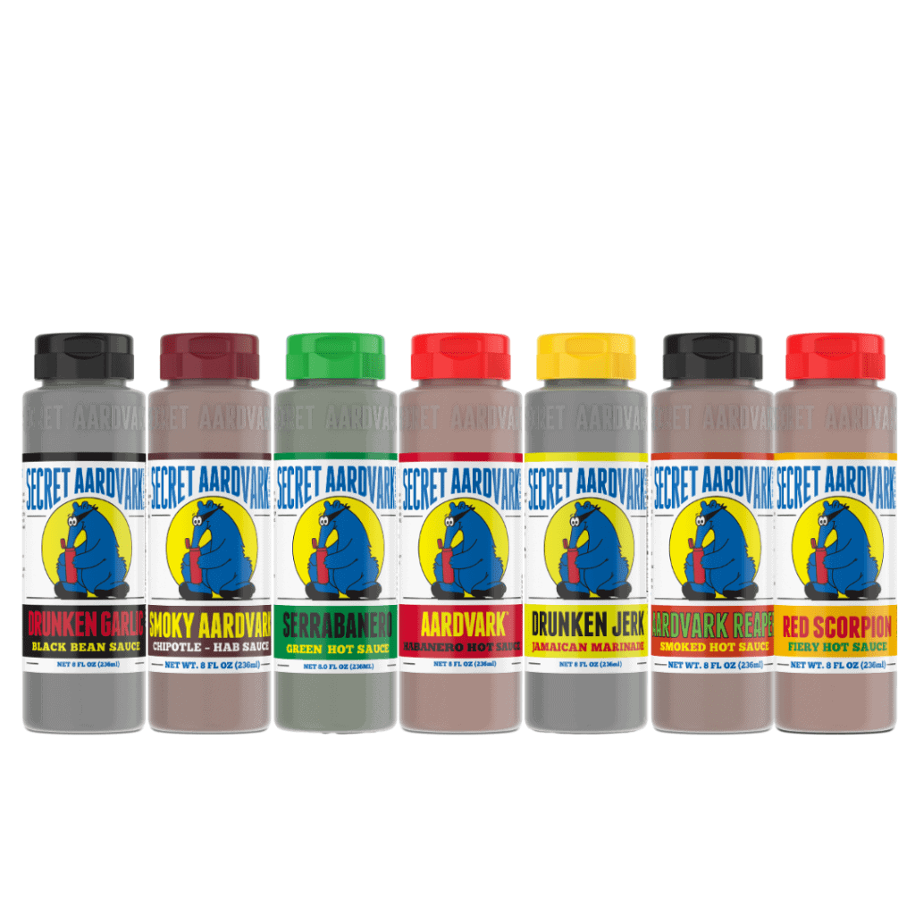 Line up of combo Mag 7: Bottle of Black Bean sauce, Smoky Aardvark, Serrabanero, Habanero, Red Scorpion, Reaper,