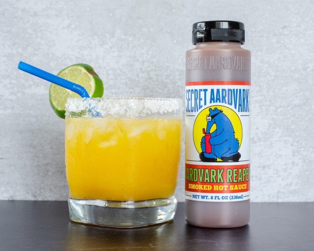 Aardvark Reaper Mango Margarita in a glass and a bottle of Aardvark Reaper 