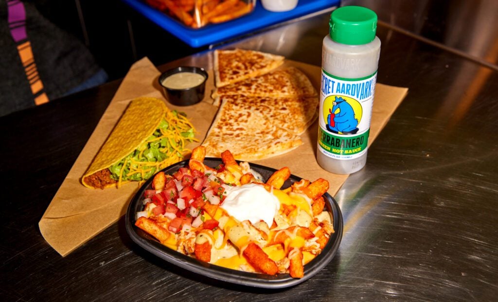nacho fries, tacos, quesadilla, and secret aardvark serrabanero sauce